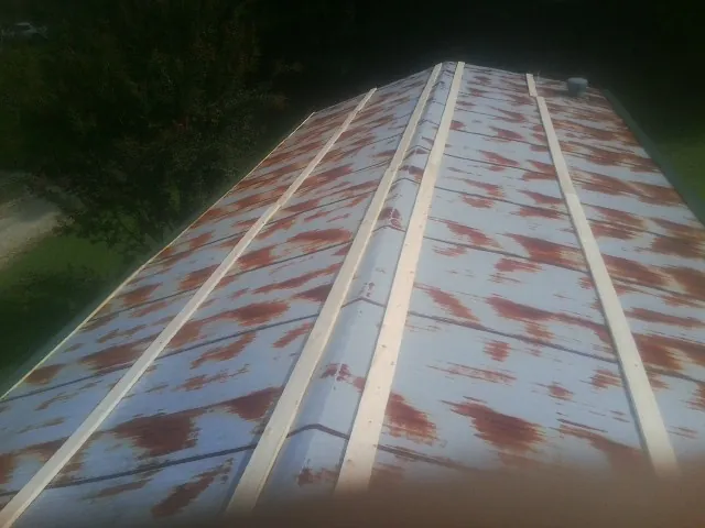 Rusted metal roof panels with new wood purlins before replacement — Storm Damage Roof Repair in Highspire by Roofing Brothers