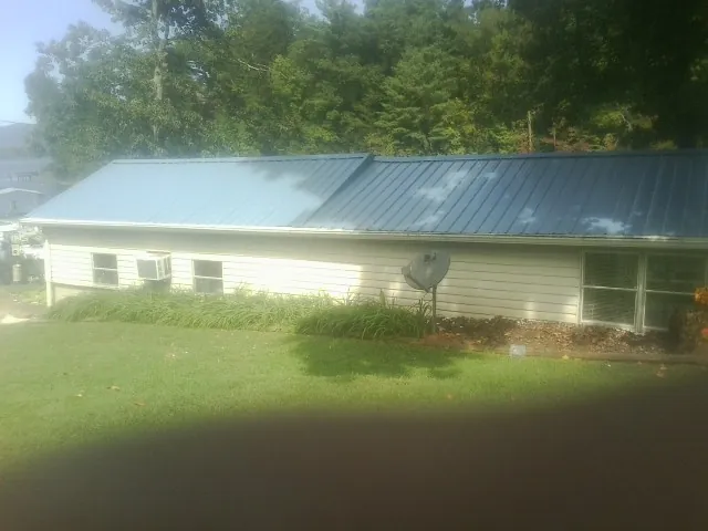Blue metal roof running the length of a single story home in Highspire