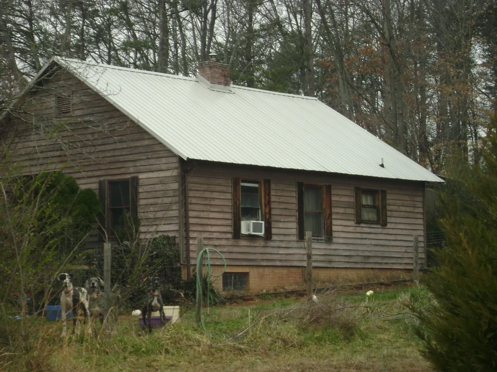 White metal roof on an old wood sided farmhouse, from a Asphalt Shingle Roof Repair job in Highspire